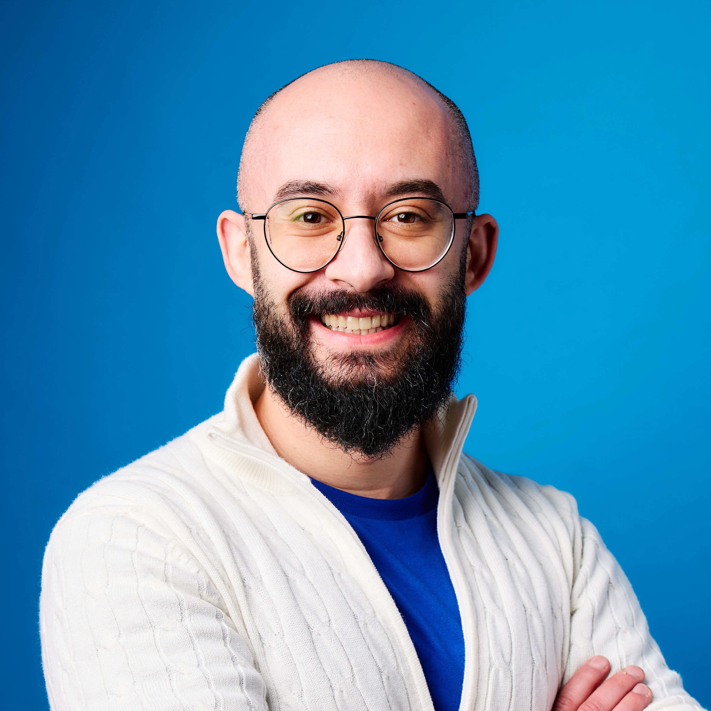 Bassem Dghaidi smiling against a blue background